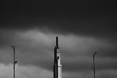 Low angle view of silhouette smoke stack against sky