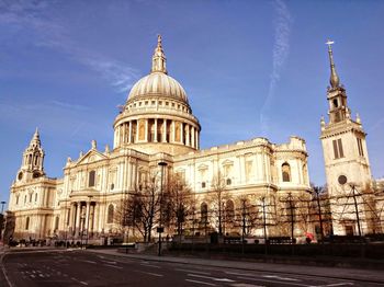 Empty road by st paul cathedral against blue sky