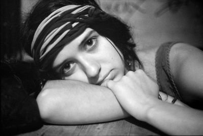 Portrait of woman leaning on table at home