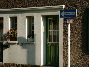 Road sign against built structure