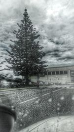 Cars on road against cloudy sky