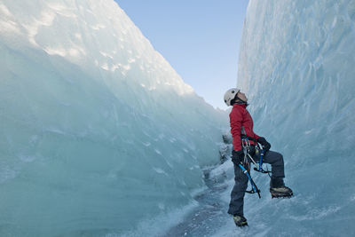 Woman climbing on the fjallsjökull glacier in iceland