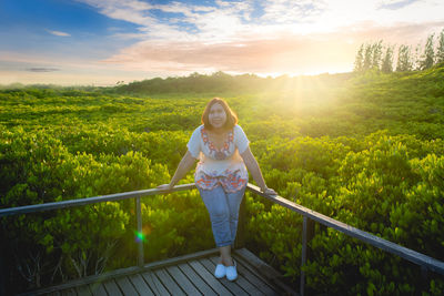 Asian woman on wooden bridge at mangrove forest thung prong thong, rayong province, thailand