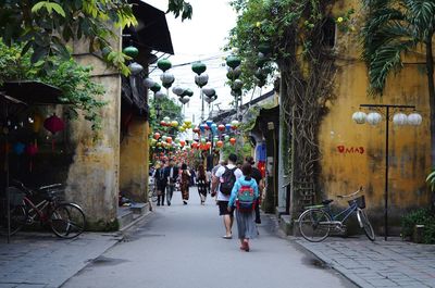 People on street amidst buildings in city