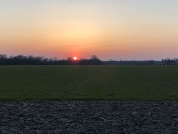 Scenic view of field against sky during sunset