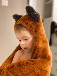 Boy with fur clothing at home