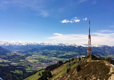 Tower with snowcapped mountain in background