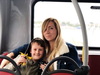 Portrait of woman with son sitting in bus