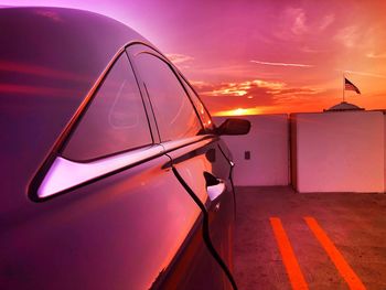 Close-up of car against sky during sunset