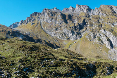 Scenic view of mountains against clear blue sky