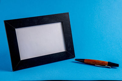 Close-up of empty laptop on blue background