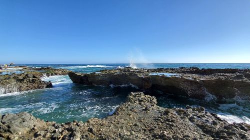 Scenic view of sea against clear blue sky