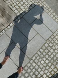 Low section of woman standing on street