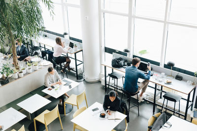 High angle view of people sitting on table