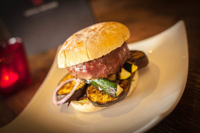 Burger in plate on table