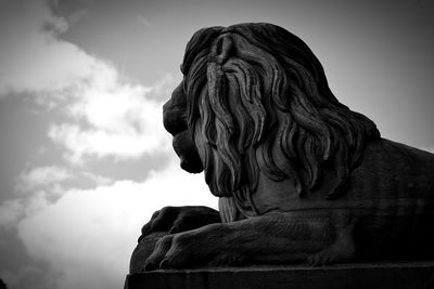 Low angle view of lion sculpture against sky