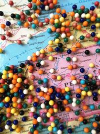 High angle view of thumbtacks on world map