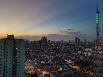 Aerial view of city lit up at sunset