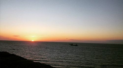 Scenic view of sea against clear sky during sunset