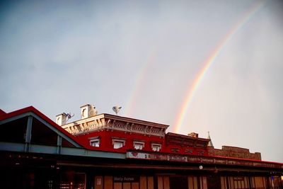 Low angle view of rainbow over building