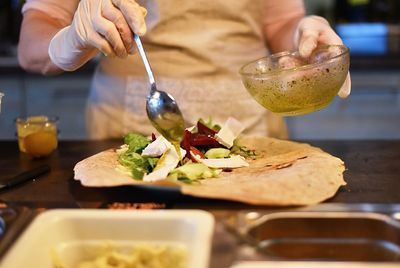 Midsection of man preparing food on table