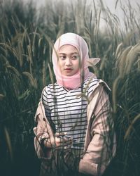 Portrait of teenage girl standing on field