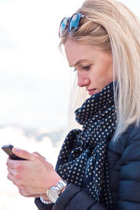 Young woman using mobile phone while standing outdoors