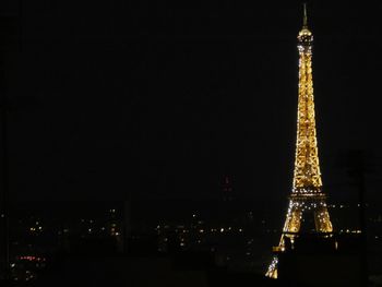 Illuminated buildings against sky at night