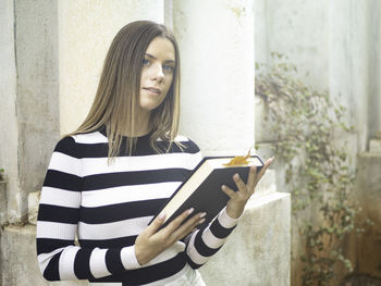 Portrait of young woman using mobile phone