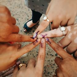 Close-up of fingers with voting marks