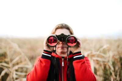 Portrait of man wearing sunglasses standing on field