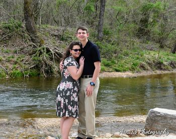 Full length of couple standing by water