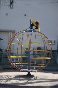 Boy playing on outdoor play equipment at playground