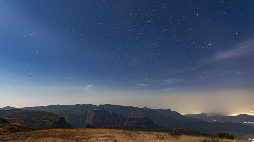 Scenic view of mountains against sky at night