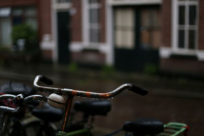 Close-up of bicycle parked on street against buildings