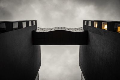 Low angle view of building against cloudy sky