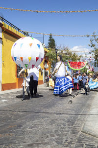 People on street at balloons