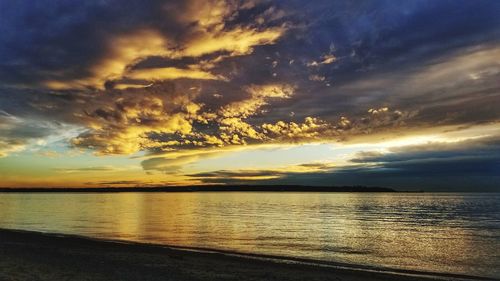 Scenic view of sea against dramatic sky