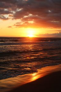 View of calm beach at sunset