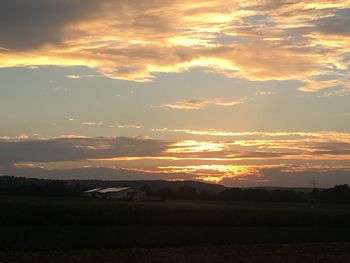 Scenic view of field against sky during sunset