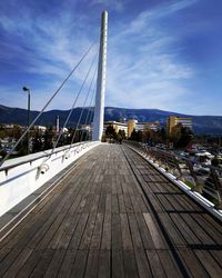 View of suspension bridge against cloudy sky