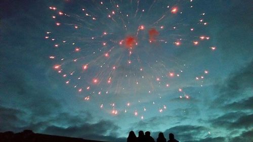 Low angle view of firework display at night