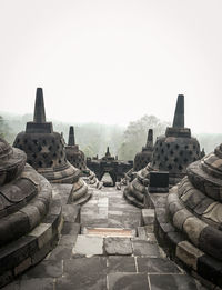 Stupas at temple against clear sky