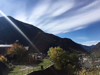 Scenic view of river by mountains against sky