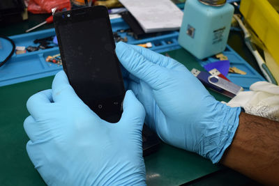 Close-up of person using smart phone on table