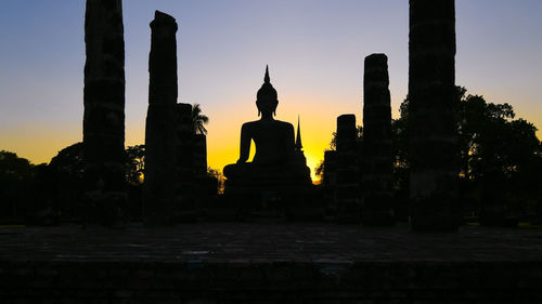 Statue of temple at sunset