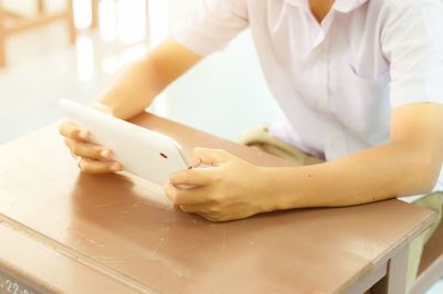 Close-up of hands on table