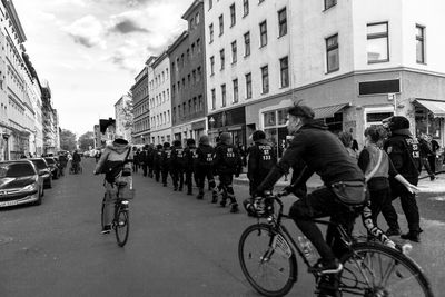People riding bicycles on street in city