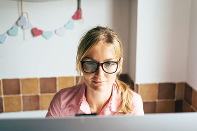 Smiling businesswoman working on computer at home