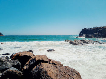 Scenic view of sea against clear sky